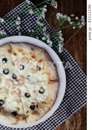 Close-up of pizza with shrimps. Seafood and vegetarian food. Italian food in restaurants and cafes. The concept of marine ingredients in meal preparation. Close-up of pizza with shrimps. Seafood and vegetarian food. Italian food in restaurants and cafes. The concept of marine ingredients in meal preparation. 83222596