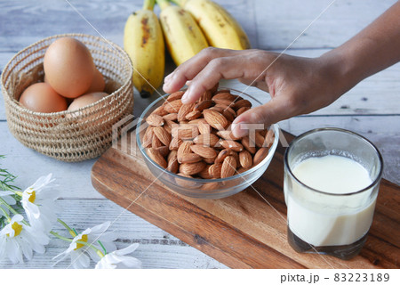 hand pick almond nut with egg and milk on table hand pick almond nut with egg and milk on table 83223189