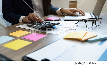 Close-up of businessman hand using calculator to calculate business data, accountancy document at home office. Close-up of businessman hand using calculator to calculate business data, accountancy document at home office. 83223937