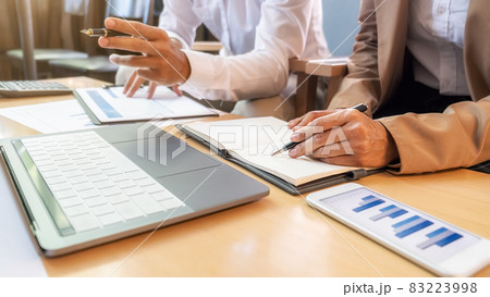 Business team brainstorming and discussing with financial data and report graph. Teamwork meeting working concept. 83223998