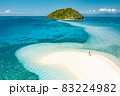 Happy woman standing on a perfect beach 83224982