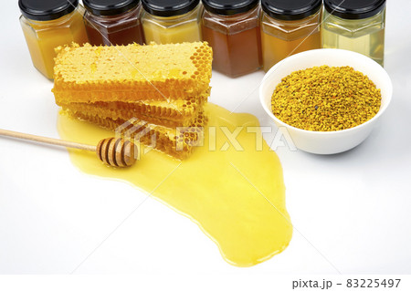 Fresh flower honey in combs and a wooden spoon. vitamin food for health and life Fresh flower honey in combs and a wooden spoon. vitamin food for health and life 83225497