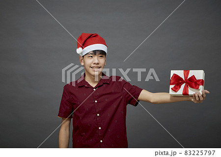 Christmas party man holding gift box 83225797
