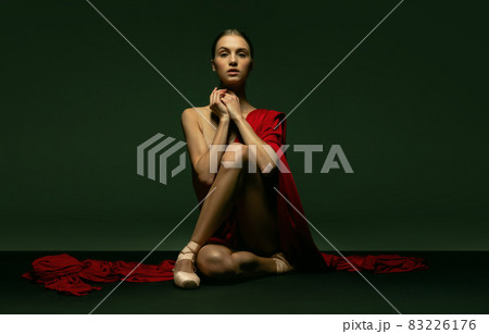 Graceful classic ballerina posing like greek goddess isolated on dark studio background. Grace, art, performance concept. Graceful classic ballerina posing like greek goddess isolated on dark studio background. Grace, art, performance concept. 83226176