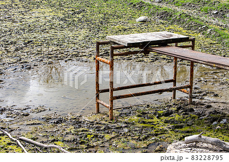 A short footbridge over a drained pond 83228795