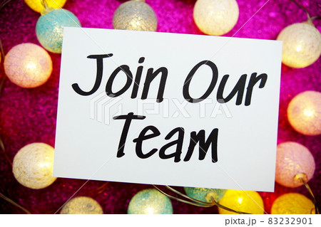Join Our Team text on paper card top view on pink bokeh background 83232901