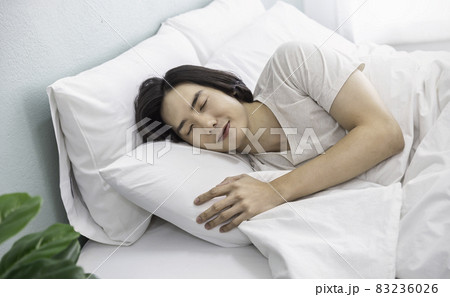 Portrait of handsome young asian man with enjoy fresh soft bedding linen mattress in white bed room modern retro apartment. Asian guy sleep resting, good night sleep concept panoramic banner Portrait of handsome young asian man with enjoy fresh soft bedding linen mattress in white bed room modern retro apartment. Asian guy sleep resting, good night sleep concept panoramic banner 83236026