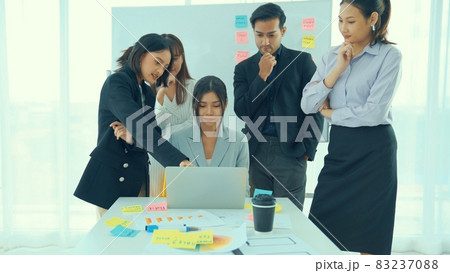 Business people proficiently discuss work project on computer 83237088