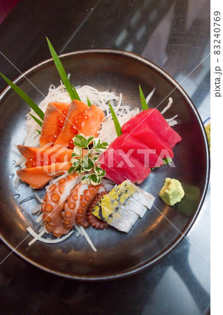 Sashimi (japanese food). Sliced raw seafood in a bowl. Sashimi (japanese food). Sliced raw seafood in a bowl. 83240769