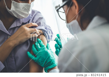 Young woman visits skillful doctor at hospital for vaccination 83241415