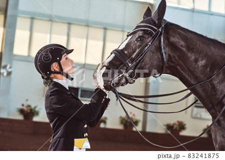 woman jockey with his horse woman jockey with his horse 83241875