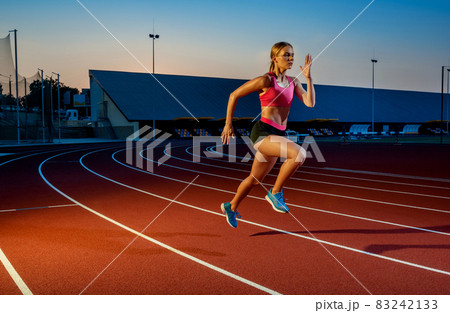 Runner sprinting towards success on run path running athletic track. Goal achievement concept. Runner sprinting towards success on run path running athletic track. Goal achievement concept. 83242133