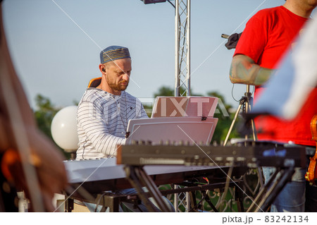 Synth player having concert rehearsal on the street Synth player having concert rehearsal on the street 83242134