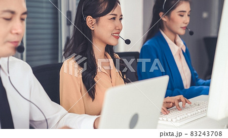 Business people wearing headset working actively in office Business people wearing headset working actively in office 83243708