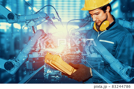 Mechanized industry robot arm and factory worker double exposure 83244786