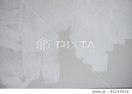 Painted wall background, Painter painting a house wall with a paint poller Painted wall background, Painter painting a house wall with a paint poller 83244916