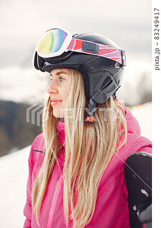 Girl snowboarding in the mountains with the snowboard Girl snowboarding in the mountains with the snowboard 83249417