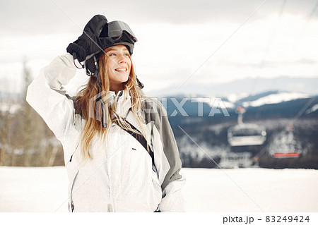 Girl snowboarding in the mountains with the snowboard 83249424
