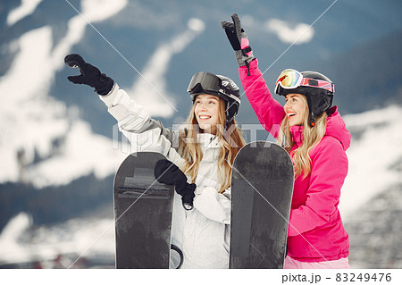 Girls snowboarding in the mountains with the snowboard 83249476