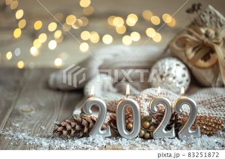 Festive New Year background with candles in the form of the numbers 2022. Festive New Year background with candles in the form of the numbers 2022. 83251872