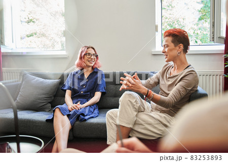 Happy lesbian married couple visiting psychologist for counseling Happy lesbian married couple visiting psychologist for counseling 83253893
