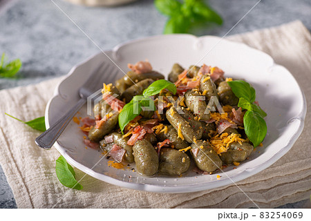 Spinach gnocchi with ham Spinach gnocchi with ham 83254069