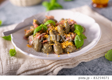Spinach gnocchi with ham Spinach gnocchi with ham 83254071