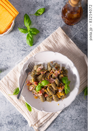 Spinach gnocchi with ham Spinach gnocchi with ham 83254072