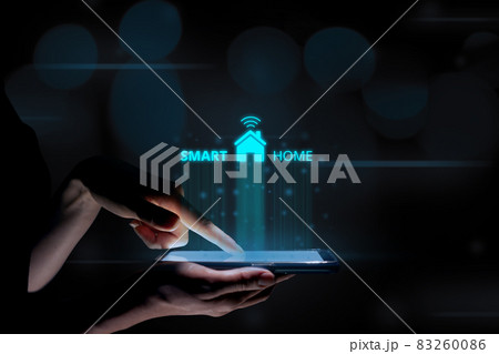 Smart home concept with a hologram over a tablet in the hands of a woman 83260086
