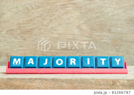 Tile alphabet letter with word majority in red color rack on wood background 83266787
