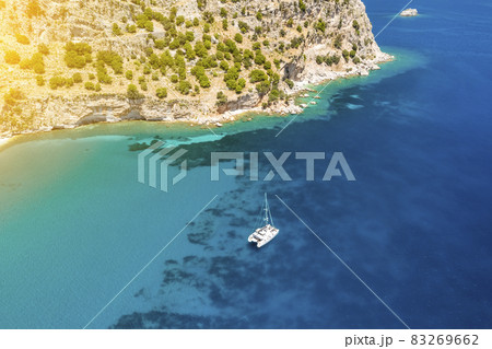 Catamaran yacht near the rocky coast in Turkey. Luxury vacation at sea 83269662
