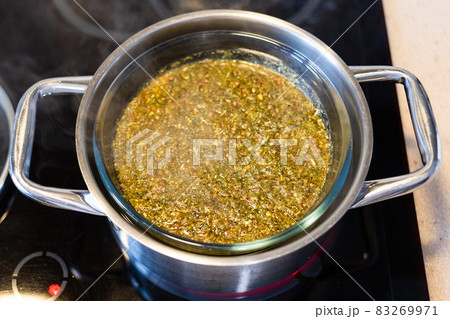 above view of boiling herbal tea in water bath 83269971