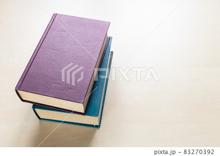 two thick volumes of books on light board 83270392