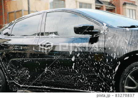 Modern car covered by foam. Car wash. Modern car covered by foam. Car wash. 83270837