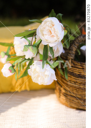 Romance, love, valentine's day concept - wicker basket with bouquet of flower on the grass. Spring fresh sunny background. Selective focus 83270870