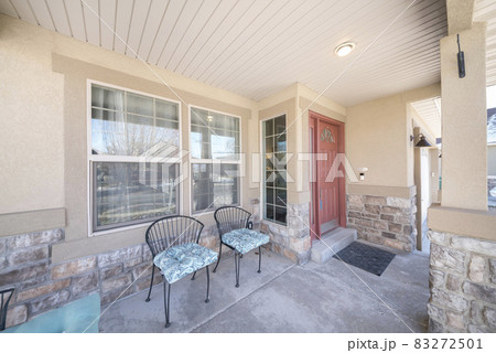 Front porch exterior with two chairs and stone sidings 83272501