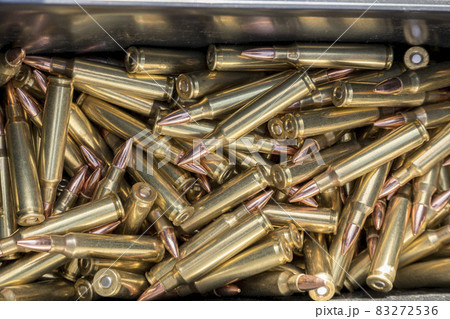 A pile of copper bullets of a gun used in shooting activity A pile of copper bullets of a gun used in shooting activity 83272536