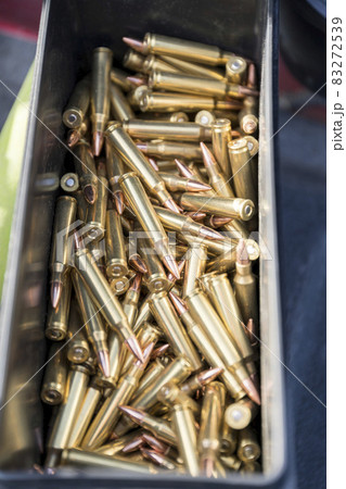 Copper bullets 223 ammo of a rifle inside a black container Copper bullets 223 ammo of a rifle inside a black container 83272539