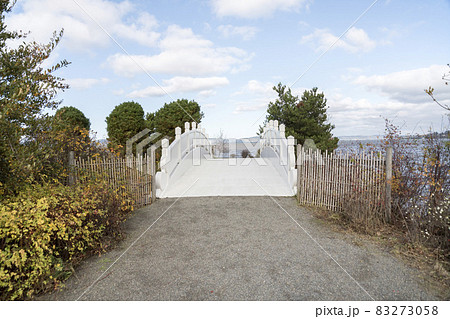 Path to a white arched bridge in the middle at Tacoma, Washington Path to a white arched bridge in the middle at Tacoma, Washington 83273058