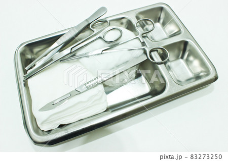 Gauze, Scalpel, Scissors and Forceps in the Stainless Steel Tray Isolated on the White Background 83273250