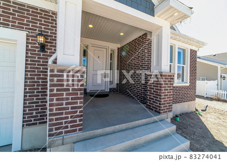 Home with steps and portico leading to the white front door between sidelights Home with steps and portico leading to the white front door between sidelights 83274041