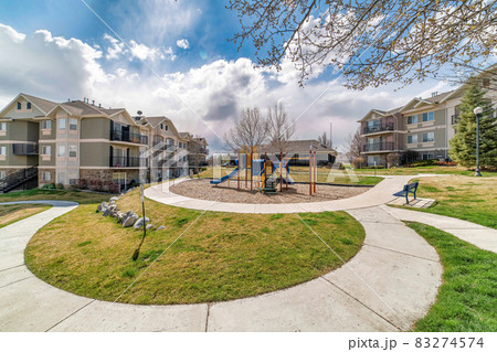 Apartment houses and kids playground on a sunny day view with cloudy blue sky 83274574