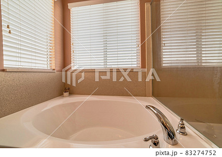 Clean polished built in round bathtub with stainless steel faucet fixture Clean polished built in round bathtub with stainless steel faucet fixture 83274752