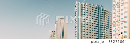 Wall With A Balcony Of New Empty Modern Multi-storey Residential Building House In Residential Area On Blue Sky. Panorama, Panoramic View Wall With A Balcony Of New Empty Modern Multi-storey Residential Building House In Residential Area On Blue Sky. Panorama, Panoramic View 83275864