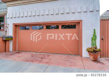 Garage of house in San Diego california with glass panes on the wide brown door 83276530