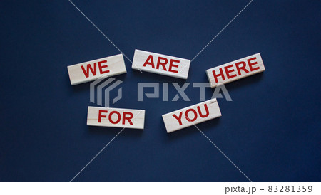 Wooden blocks with text 'we are here for you'. Beautiful white background, copy space. Business concept. 83281359