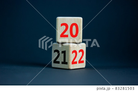 2022 happy new year symbol. Turned cubes, symbolize the change from 2021 to the new year 2022. Beautiful grey table, grey background. Copy space. Business and 2022 happy new year concept. 83281503