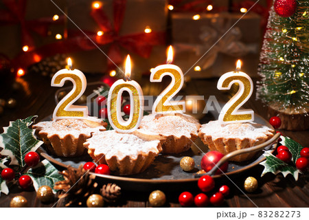 Food tray with cupcakes new year candles and christmas decorations Food tray with cupcakes new year candles and christmas decorations 83282273