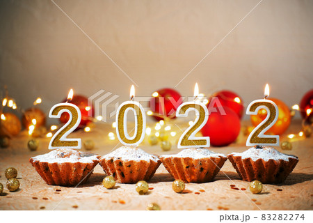 New year party number candles and cupcakes on christmas decorations background New year party number candles and cupcakes on christmas decorations background 83282274