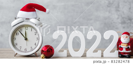 Merry Christmas with Vintage alarm clock and 2022 number on wooden table. Happy new Year, party, holiday and boxing day concept Merry Christmas with Vintage alarm clock and 2022 number on wooden table. Happy new Year, party, holiday and boxing day concept 83282478